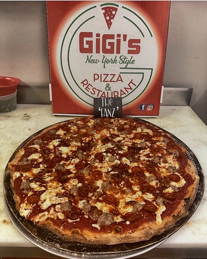 The Fanz specialty pizza — pepperoni, sausage and ricotta dollops on a silver pan