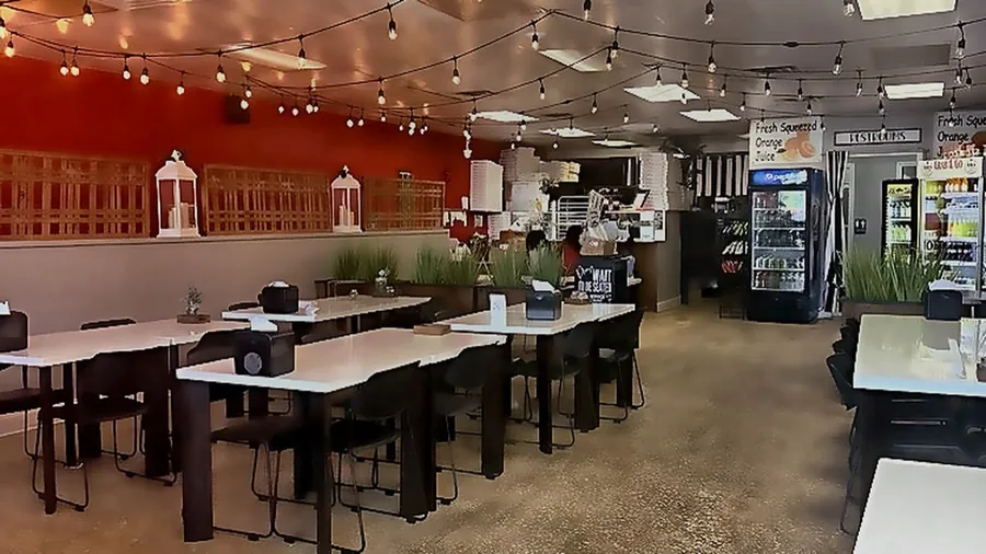Gigi's dining room at 140 Brighton Avenue, Long Branch, with string lights and the red accent wall
